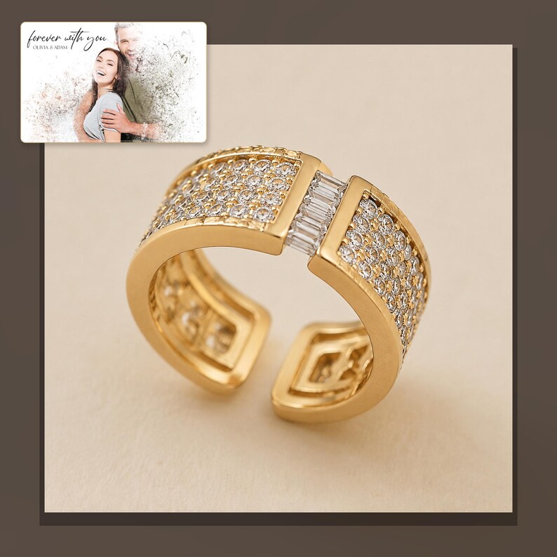 Gold-tone open ring with rows of clear accents, alternate framed view. A personalized greeting-card example appears in the corner.