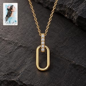 Oval Link Moissanite Necklace, shown against a dark background. A sample personalized digital greeting card is shown alongside.