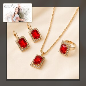 Red rectangular-stone necklace, matching earrings and ring, dark-bordered product view. A personalized greeting-card example appears in the corner.