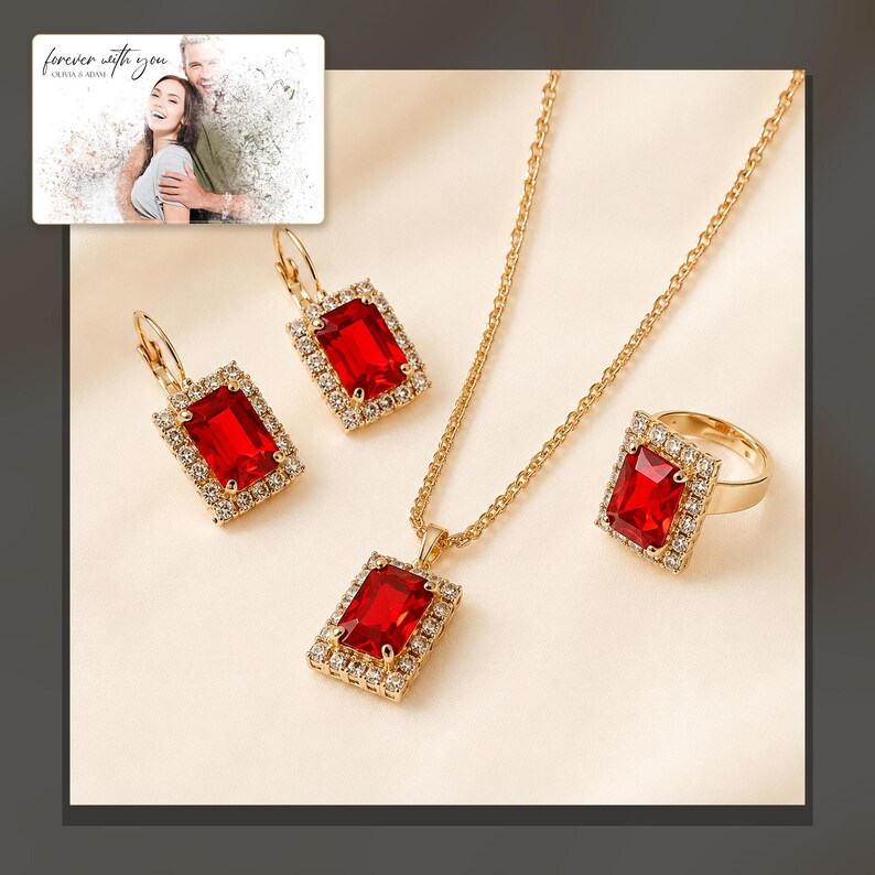 Red rectangular-stone necklace, matching earrings and ring, dark-bordered product view. A personalized greeting-card example appears in the corner.