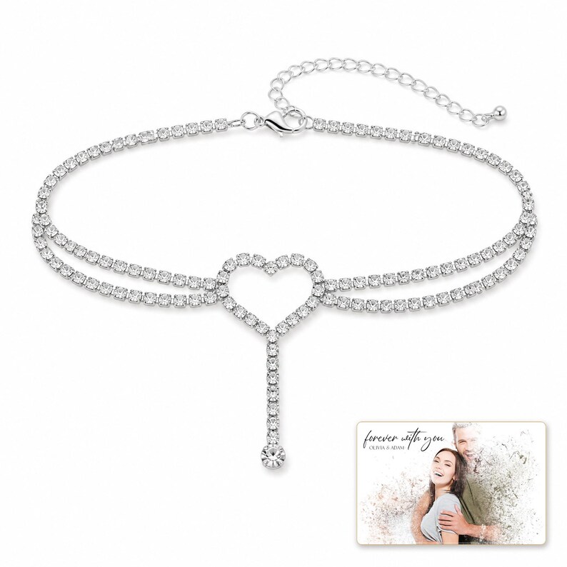 Lovelight Crystal Heart Anklet shown during a believable gift-giving moment between adults with the exact jewelry visible.