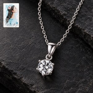 Moissanite Pendant Necklace, shown against a dark background. A sample personalized digital greeting card is shown alongside.