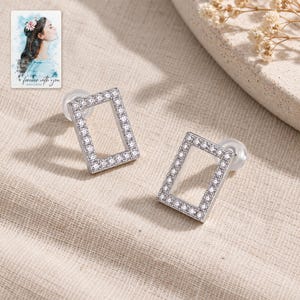 Rectangle Moissanite Stud Earrings, laid on fabric. A sample personalized digital greeting card is shown alongside.