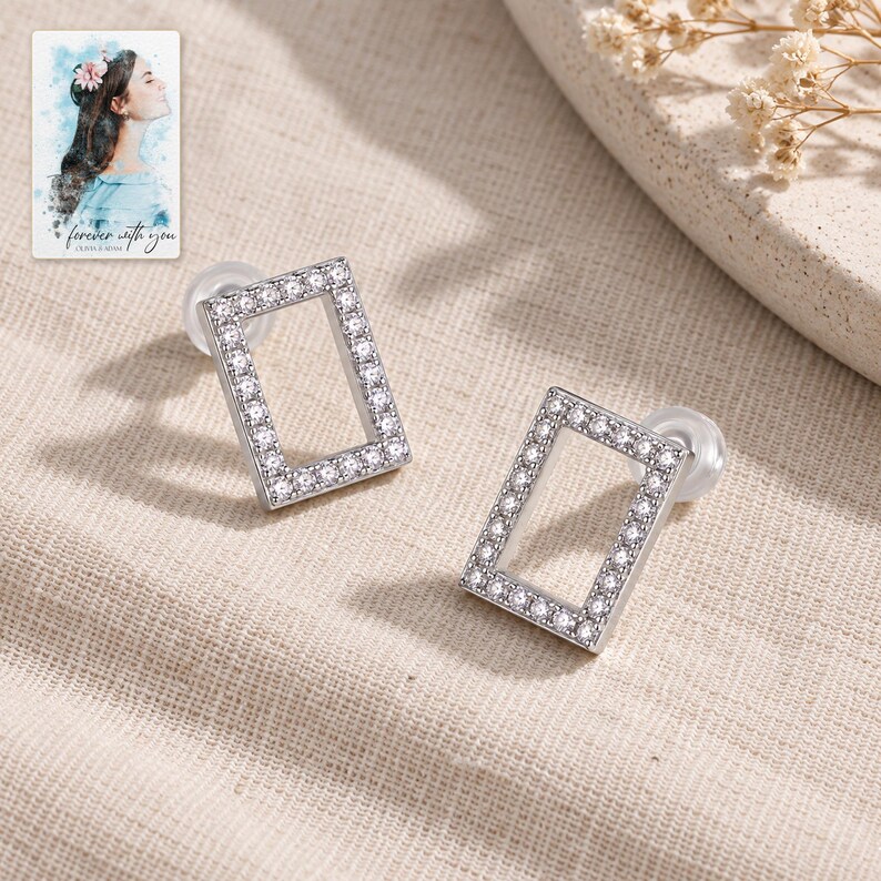Rectangle Moissanite Stud Earrings, laid on fabric. A sample personalized digital greeting card is shown alongside.