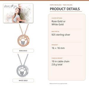 White Gold color HOPE heart pendant arranged on soft ivory linen in a refined neutral flat lay.
