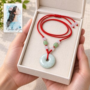 Peace Circle Green Cord Necklace shown during a believable gift-giving moment between adults with the jewelry visible. A personalized digital greeting card is shown alongside.