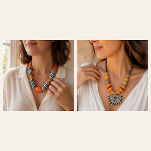 May include: A necklace featuring orange beads and black and white striped beads, alongside a second necklace with orange beads, patterned beads, and a large silver-toned semi-circular pendant with intricate metalwork and small dangling spheres.