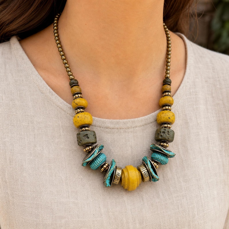Rose Gold and Gray Statement Beaded Necklace presented in an open jewelry gift box on natural linen