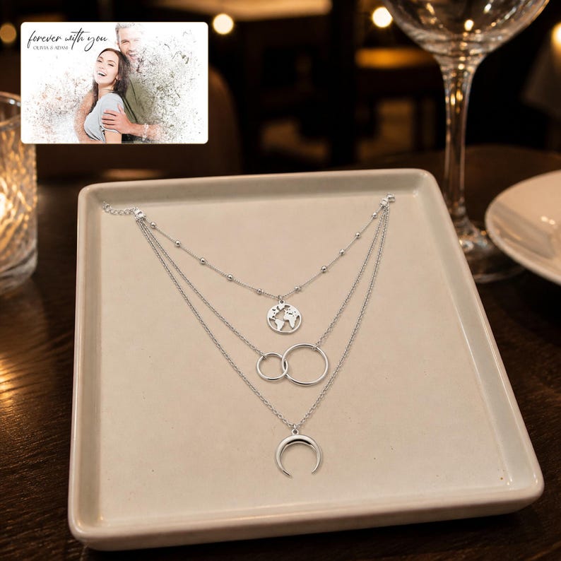 Silver Moon Map Layers arranged on soft ivory linen in a refined neutral flat lay.