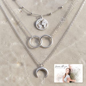 Silver Moon Map Layers shown during a warm gift-receiving moment between adults with the exact jewelry visible.
