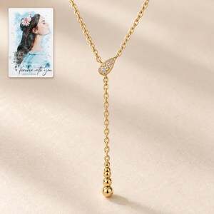 Moissanite Y Necklace, hero view. A personalized digital greeting card is shown alongside.