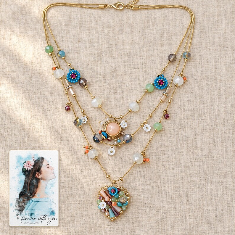Bohemian Heart Cascade Necklace arranged on soft ivory linen in a refined neutral flat lay. A personalized digital greeting card is shown alongside.