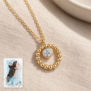 Moissanite Circle Necklace, linen flatlay view. A personalized digital greeting card is shown alongside.
