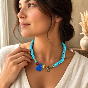 Blue and Silver Statement Beaded Necklace displayed on a jewelry bust with the layered beadwork and pendants visible