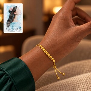 Golden Spiral Bead Slider Bracelet worn by an adult in a polished evening lifestyle scene. A personalized digital greeting card is shown alongside.