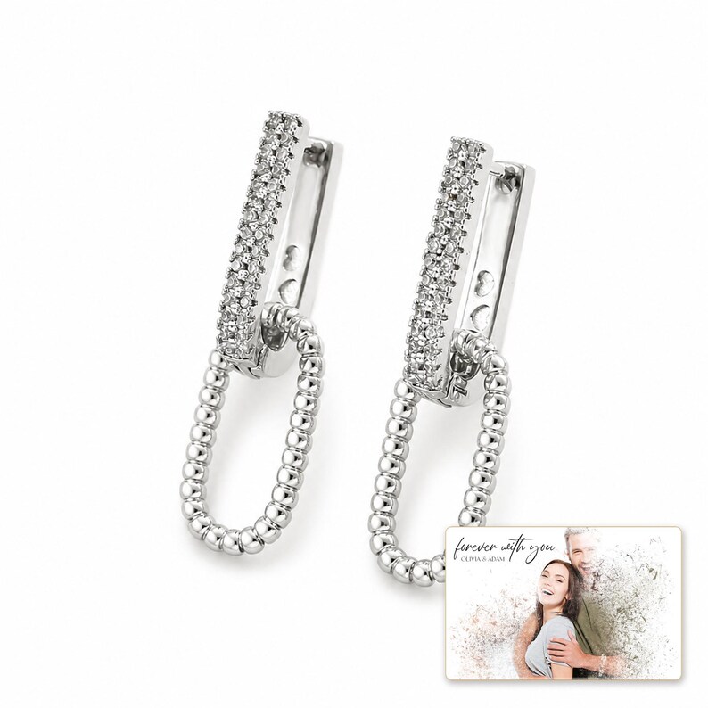 Silver Current Zircon Drops shown during a believable gift-giving moment between adults with the exact jewelry visible.