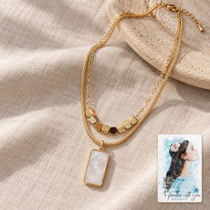 Mother of Pearl Necklace, linen flatlay view. A personalized digital greeting card is shown alongside.
