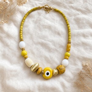 Rose Gold and Beige Statement Beaded Necklace presented in an open jewelry gift box on natural linen