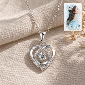 Moissanite Heart Necklace, linen flatlay view. A personalized digital greeting card is shown alongside.