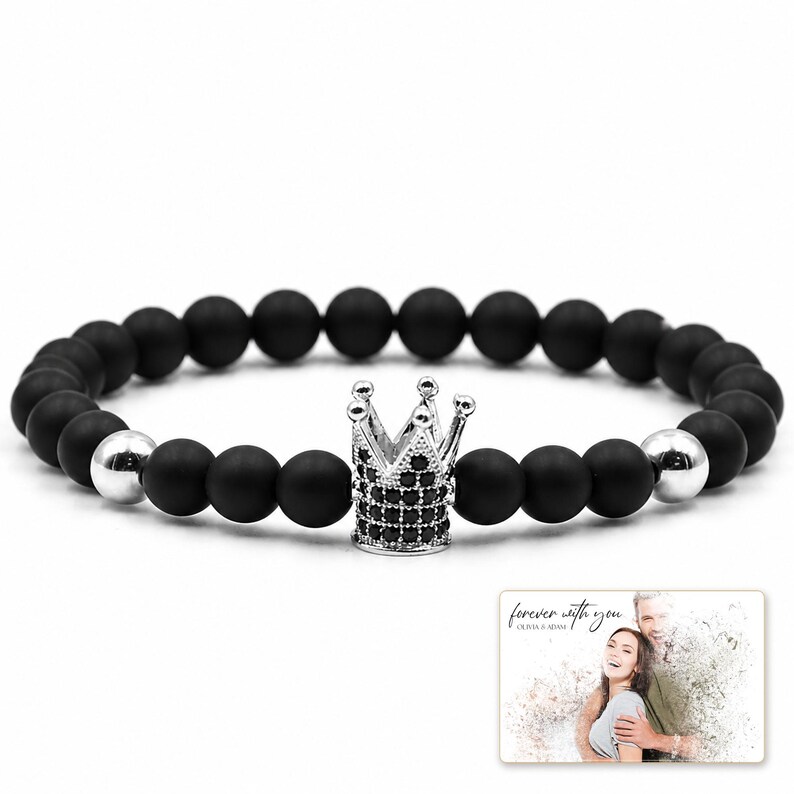 Midnight Crown Bead Bracelet shown during a believable gift-giving moment between adults with the exact jewelry visible.