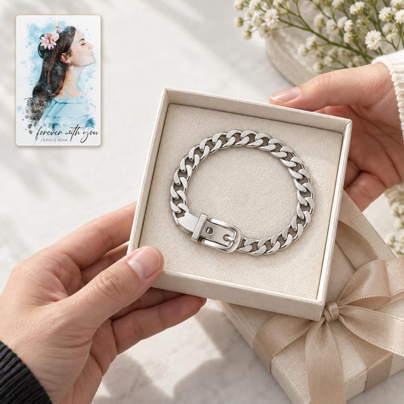Adult hands passing an open ivory box containing the closed silver tone belt buckle bracelet. A personalized digital greeting card is shown alongside.