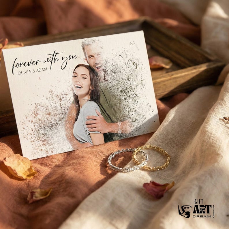 May include: A greeting card with the words "forever with you" and the names Olivia & Adam. The card features a photo of a couple. Two textured rings, one silver and one gold, are next to the card. The background is a soft, neutral color.