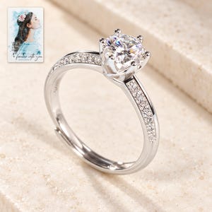 Moissanite Solitaire Ring, close-up of the details. A sample personalized digital greeting card is shown alongside.