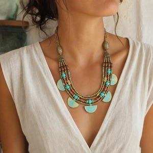 Gray and Silver Statement Beaded Necklace presented in an open jewelry gift box on natural linen
