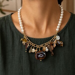 Three-piece handmade necklace set featuring bronze and brown beaded necklace, gray and brown beaded necklace and silver and bronze beaded necklace, displayed together to show the coordinated colors and beadwork