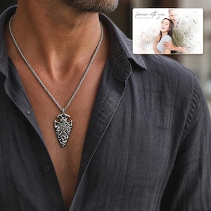 Aegis North Nordic Arrowhead Necklace worn by an adult in a polished evening lifestyle scene.