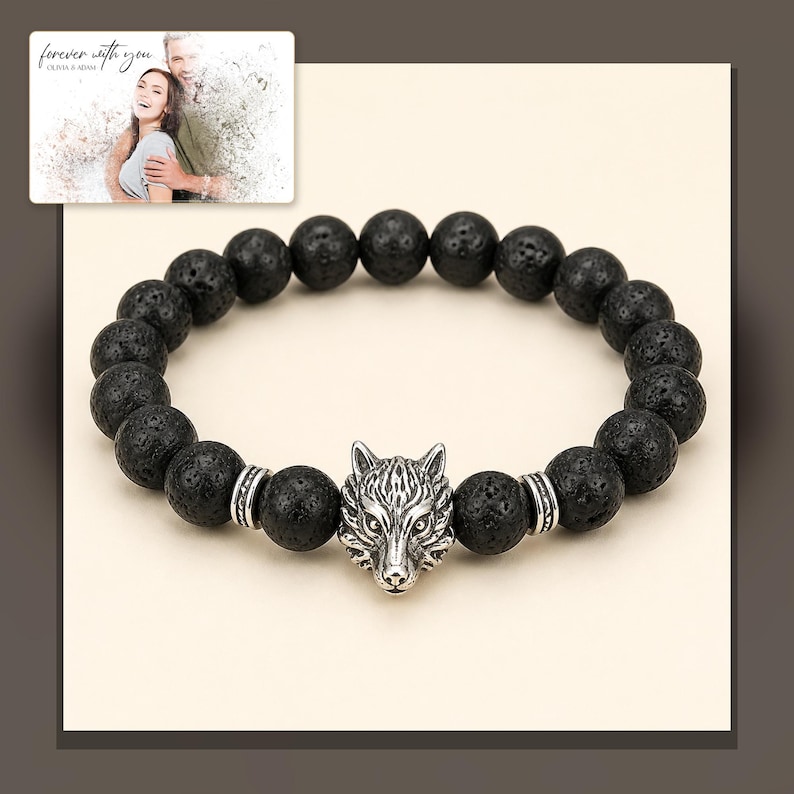 Black bead bracelet with silver-tone wolf-head detail, alternate framed view. A personalized greeting-card example appears in the corner.