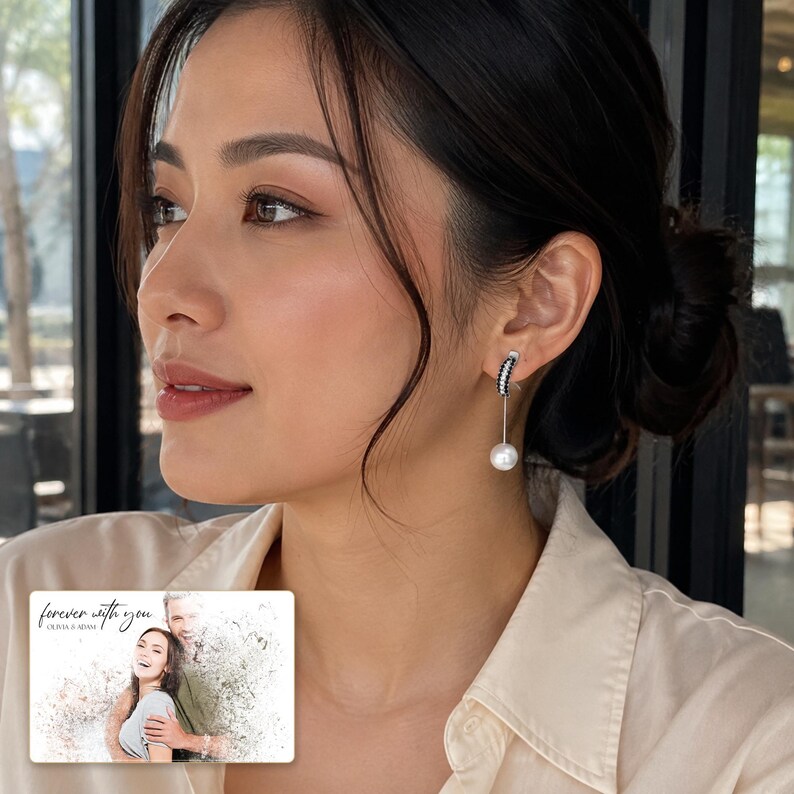 Silver-tone curved drop earrings with black accents and white round drops, adult lifestyle view. A personalized greeting-card example appears in the corner.