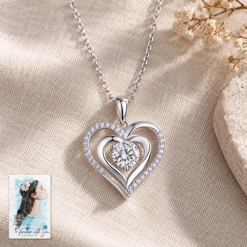 Double Heart Moissanite Necklace, laid on fabric. A sample personalized digital greeting card is shown alongside.