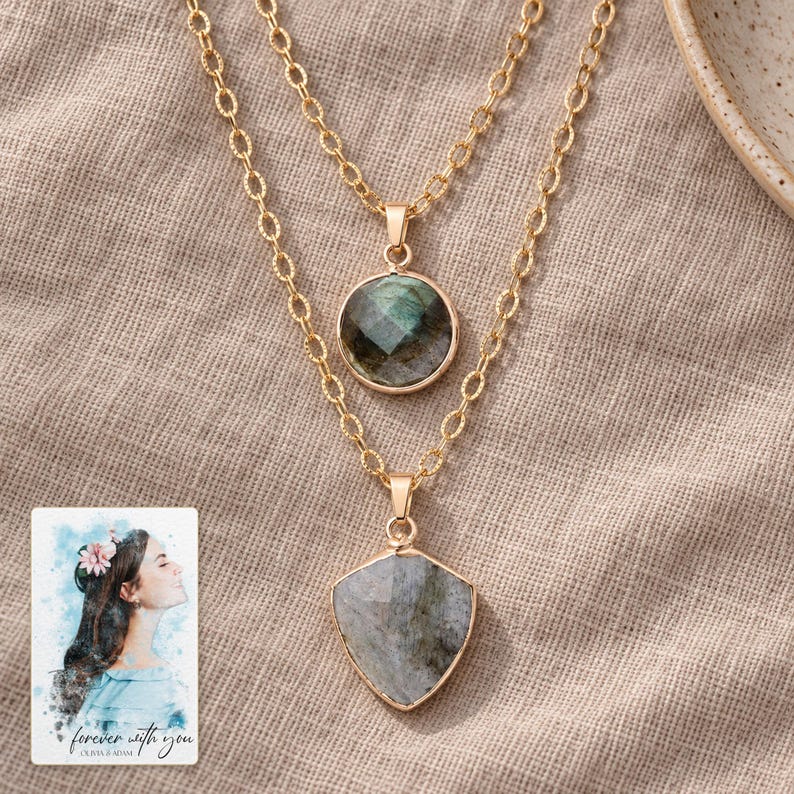 Layered Shield Necklace, linen flatlay view. A personalized digital greeting card is shown alongside.