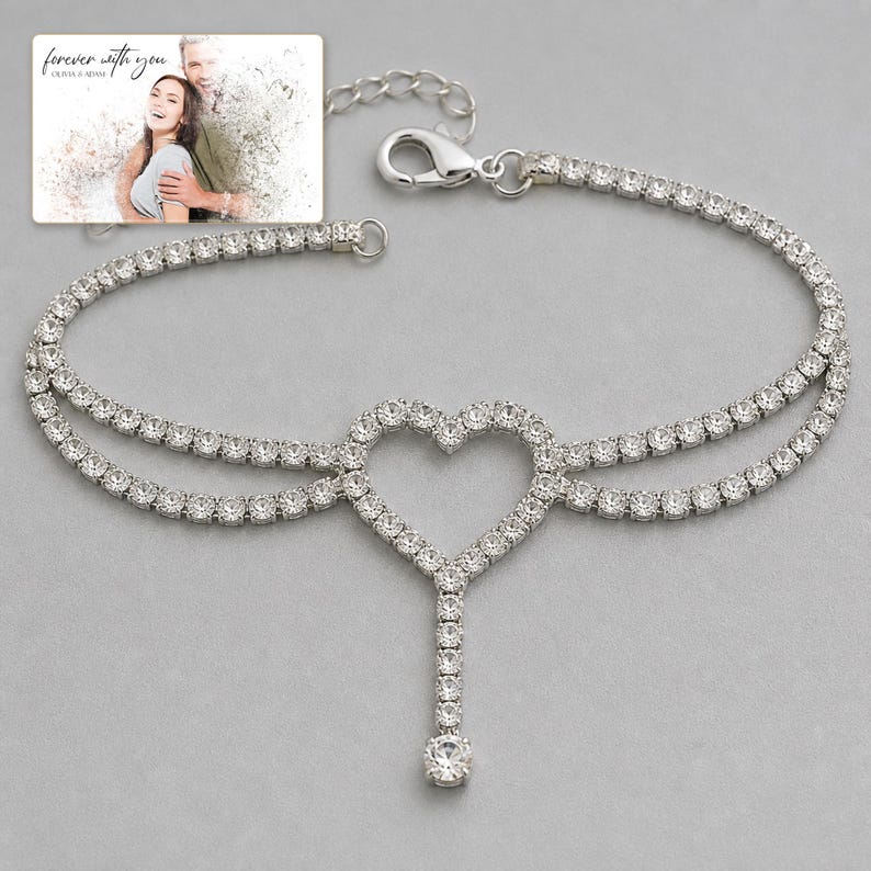 Lovelight Crystal Heart Anklet shown during a warm gift-receiving moment between adults with the exact jewelry visible.