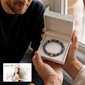 Storm Marbled Leopard Bracelet shown during a warm gift-receiving moment between adults with the exact jewelry visible.