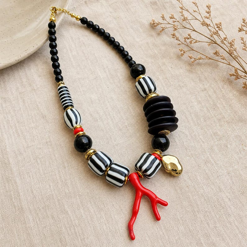 Red and Silver Statement Beaded Necklace presented in an open jewelry gift box on natural linen