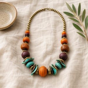 Rose Gold and Silver Statement Beaded Necklace presented in an open jewelry gift box on natural linen