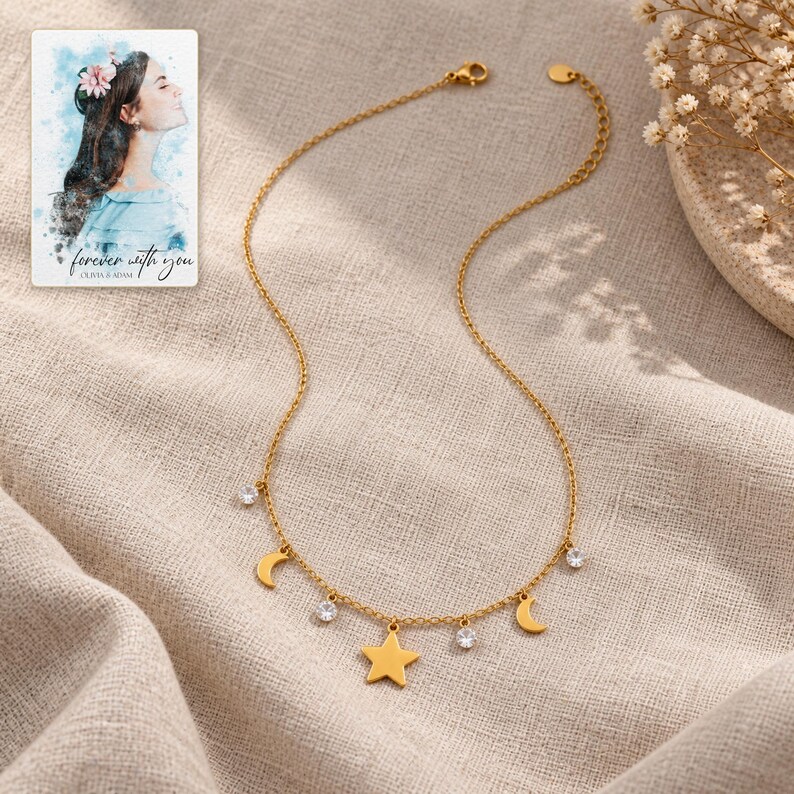 Moon and Star Necklace, laid on fabric. A sample personalized digital greeting card is shown alongside.