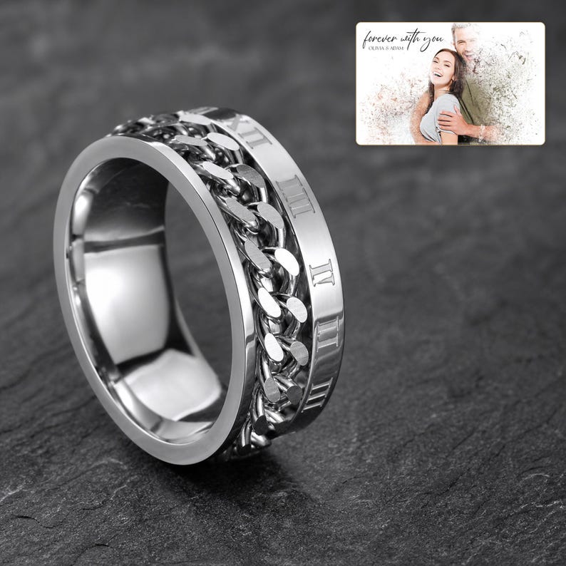 CipherSpin Roman Chain Ring shown during a warm gift-receiving moment between adults with the exact jewelry visible.