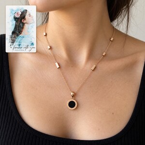 Roman Numeral Necklace, worn lifestyle view. A personalized digital greeting card is shown alongside.