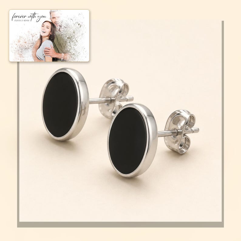 Black oval stud earrings with silver-tone edges, light-bordered product view. A personalized greeting-card example appears in the corner.