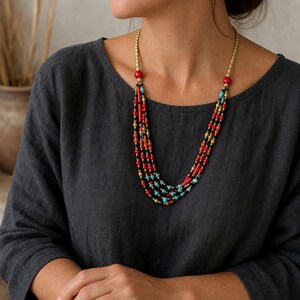 Red and Brown Statement Beaded Necklace, Boho Handmade Jewelry, Artisan Gift for Her worn with a charcoal linen top in a natural outdoor setting