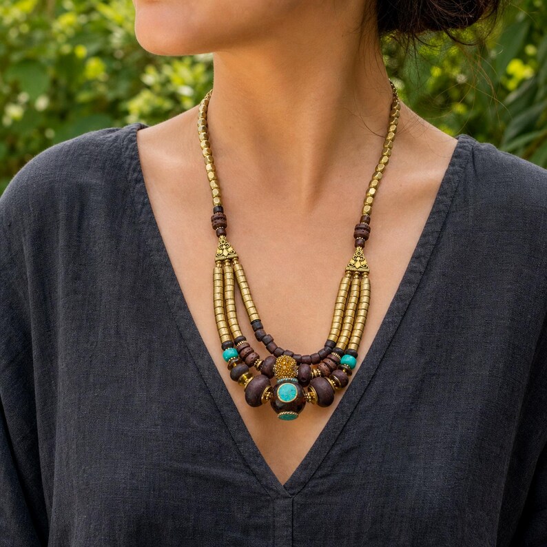 Three-piece handmade necklace set featuring beige and brown beaded necklace, orange and brown beaded necklace and orange and brown beaded necklace, displayed together to show the coordinated colors and beadwork