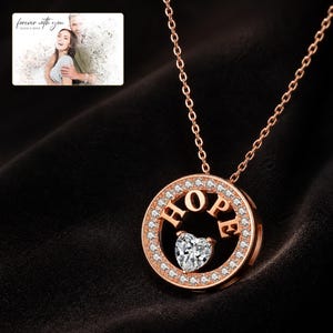 Rose Gold sterling silver HOPE necklace glowing against a dark luxury surface with crisp CZ sparkle.