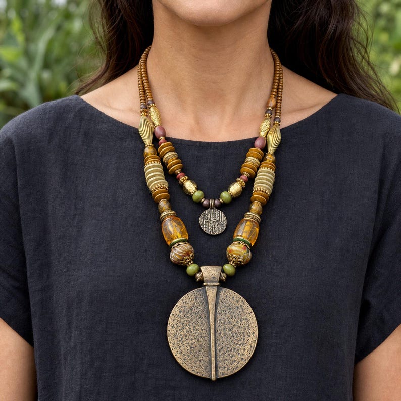 Three-piece handmade necklace set featuring beige and bronze beaded necklace, bronze and beige beaded necklace and silver and bronze beaded necklace, displayed together to show the coordinated colors and beadwork