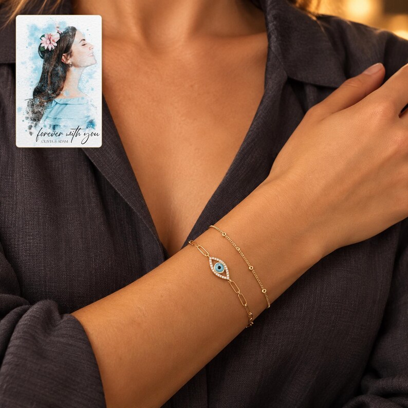 Gold Tone Evil Eye Bracelet Duo worn by an adult in a polished evening lifestyle scene. A personalized digital greeting card is shown alongside.