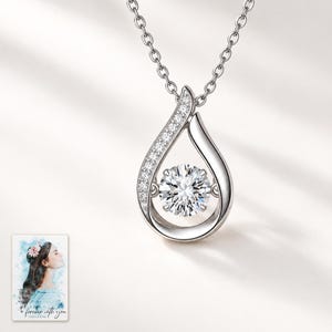 Moissanite Teardrop Necklace, shown against a light background. A sample personalized digital greeting card is shown alongside.