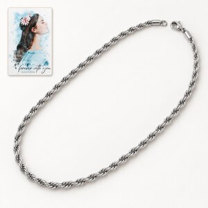 Single silver-tone rope necklace laid in an elongated oval on an ivory-white background. A personalized digital greeting card is shown alongside.