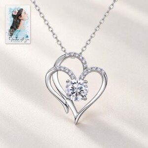 Double Heart Pendant Necklace, shown against a light background. A sample personalized digital greeting card is shown alongside.